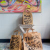 3 paper bags with black handwritten title: Thank you for being an Artist